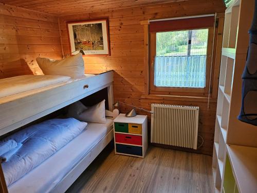 a room with two beds in a wooden cabin at Ferienhaus Gerdi in Schwarz