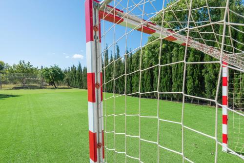 a soccer goal with a field of grass at Ses Veles in Lloseta