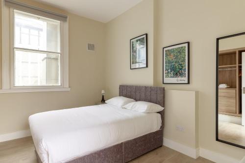 Dublin Castle Suites في دبلن: غرفة نوم بسرير كبير ونافذة