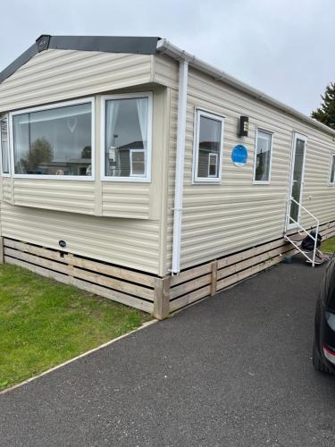 a mobile caravan is parked in a parking lot at Angella's Caravan - Morecambe in Morecambe