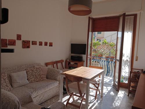 a living room with a couch and a table at Home Caviglia CITRA 09029-LT-0618 in Finale Ligure
