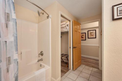 a bathroom with a shower and a walk in closet at FF215 First Flight Retreat 215 in Kill Devil Hills