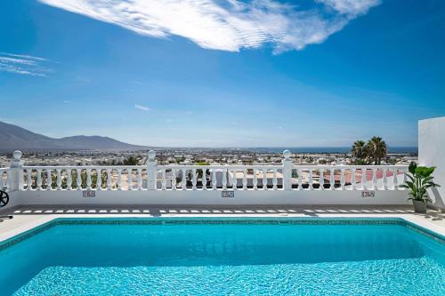 a swimming pool on the balcony of a house at Field of Dreams in Playa Blanca