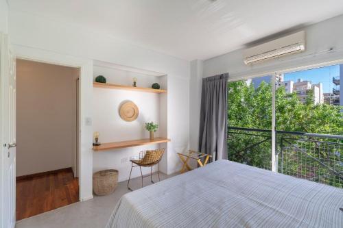 a bedroom with a bed and a large window at Dúplex muy amplio para familias | Las Cañitas in Buenos Aires
