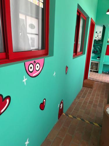 a room with a blue wall with hearts on the wall at Pousada Bat N Breakfast No Beco do Batman in Sao Paulo