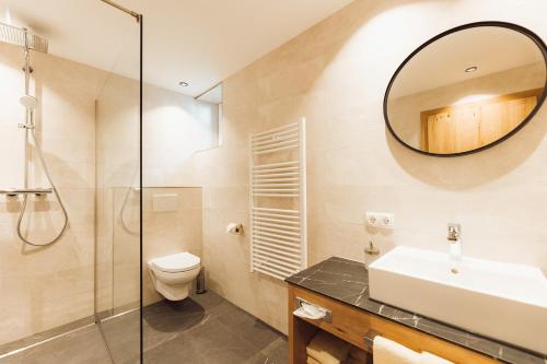 a bathroom with a sink toilet and a mirror at Apart Himmel-Raich in Kaunertal