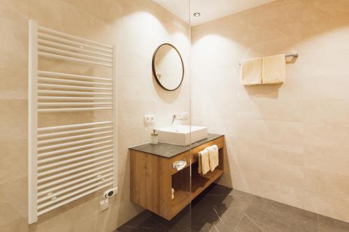a bathroom with a sink and a mirror at Apart Himmel-Raich in Kaunertal