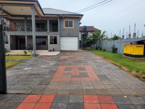 an empty driveway in front of a house at Stylish House with Generator - Tema Community 25 in Hanya