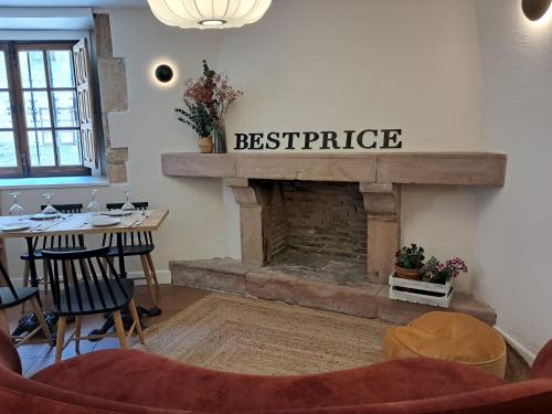 a living room with a fireplace with a sign that reads satisfaction at Hotel BESTPRICE Santillana in Santillana del Mar