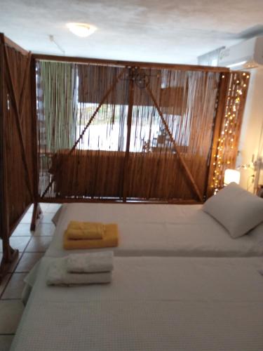 a room with a bed with atainedigunigunigun at PRIVATE SEASIDE GUEST HOUSE... in Agia Marina Mikrolimanou