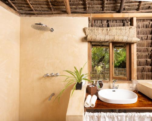 a bathroom with a sink and a window at The Cabanas Lamu in Lamu