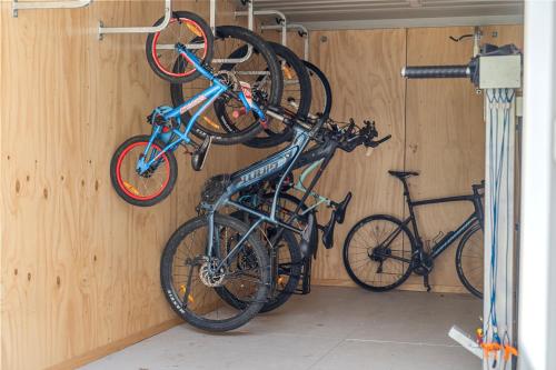 two bikes hanging on a wall in a garage at Tasman Holiday Parks - Christchurch in Christchurch