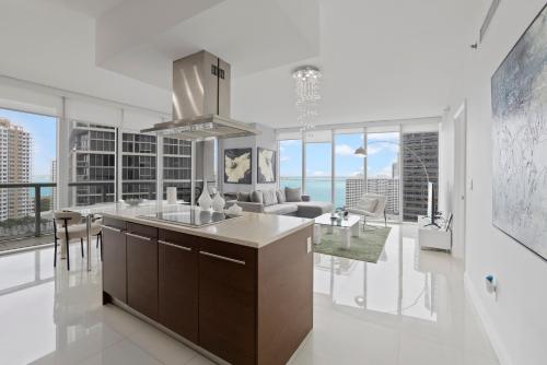 a kitchen and living room with a view of the ocean at 2B2B w Water View - FREE Parking - Pool - Lux Spa in Miami