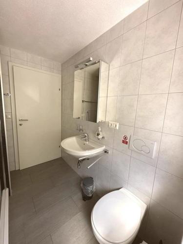 a bathroom with a toilet and a sink at Ferienwohnung Chow Chow in Nauders