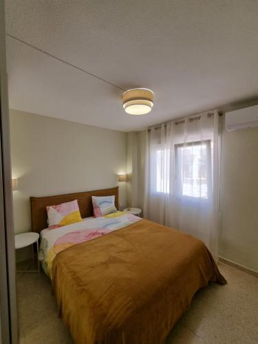 a bedroom with a large bed and a window at Aleksandra Apartament Sant Francesc in El Campello