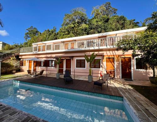 a house with a swimming pool in front of it at Hotel Casablanca Koeler in Petrópolis