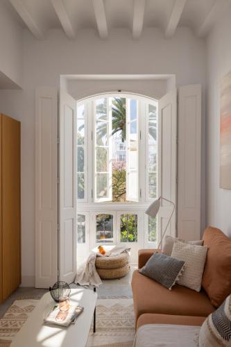a living room with a couch and a large window at Candelaria10 in Cádiz