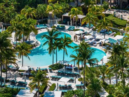 an aerial view of a resort pool with palm trees at Studio Located at The Ritz Carlton Key Biscayne, Miami in Miami