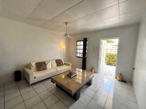 a living room with a couch and a coffee table at Kenepa Apartments in Willemstad
