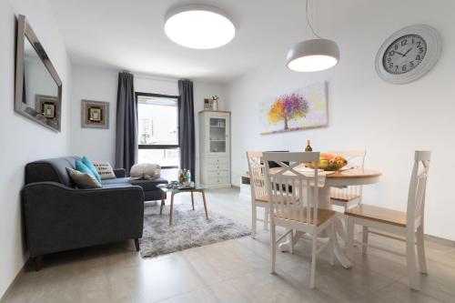 a living room with a table and a dining room at King David Apartment - J&J in Jerusalem