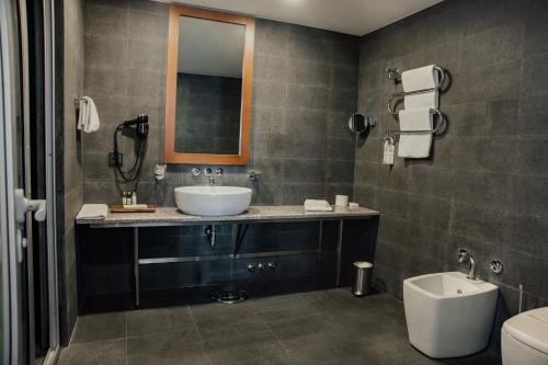 a bathroom with a sink and a toilet at Avala Resort & Villas in Budva