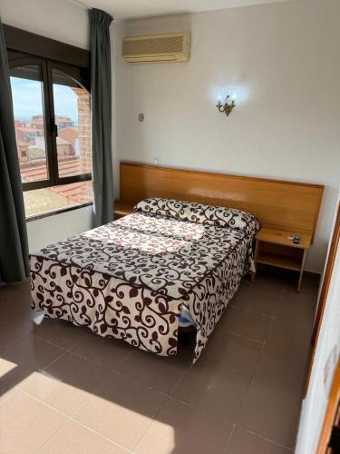 a hotel room with a bed and a window at Hostal cazalegas in Cazalegas