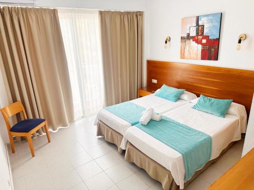 pokój hotelowy z łóżkiem i krzesłem w obiekcie Hotel Selva Arenal w El Arenal