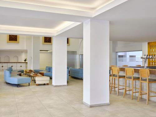 a living room with chairs and a table at Atlantica Panthea Resort in Ayia Napa