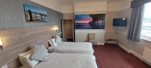 a hotel room with two beds and a window at Best Western Hotel Hatfield in Lowestoft
