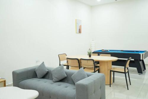 a living room with a couch and a pool table at NEW-Batu Pahat 10pax Mahjong Snooker BBQ in Batu Pahat