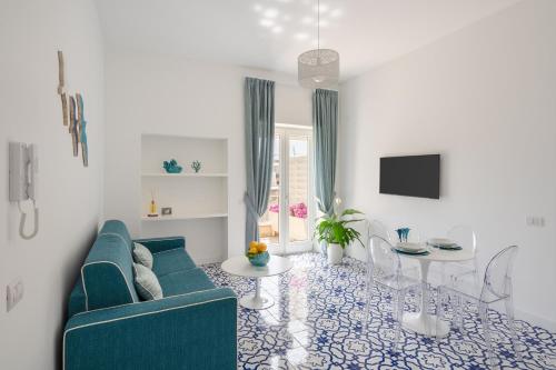 a living room with a blue couch and a table at Casa Levante Luxury Apartments Capri in Capri