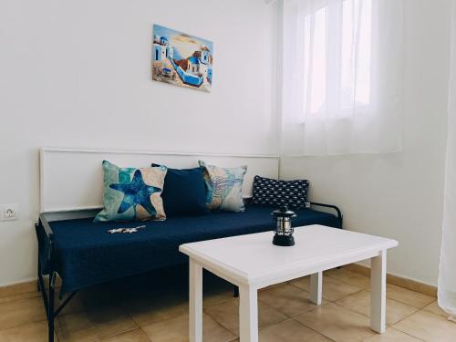 a living room with a couch and a table at Nautilus City Studios & Apartments in Rhodes Town