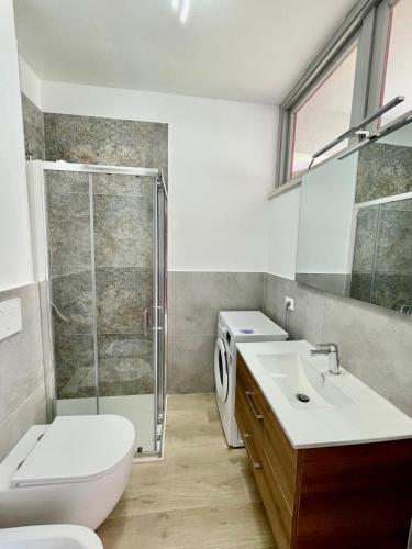 a bathroom with a shower and a toilet and a sink at Premium Apartment Mono A1 in Marina di Bibbona
