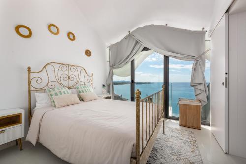 a bedroom with a bed with a view of the ocean at RentitSpain Casa Acantilado in Granada
