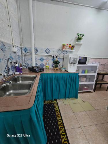 a kitchen with a sink and a counter top at Maisarah Homestay Melaka, Islamic Home in Melaka in Melaka