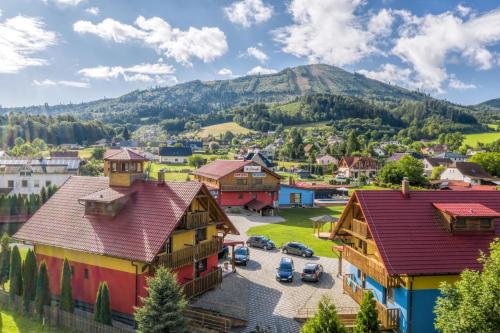 a village in the mountains with cars parked at Wellness & Restaurant U Fandy in Lhotka