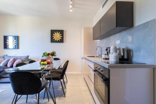 a kitchen and dining room with a table and chairs at King David Apartment - J&J in Jerusalem