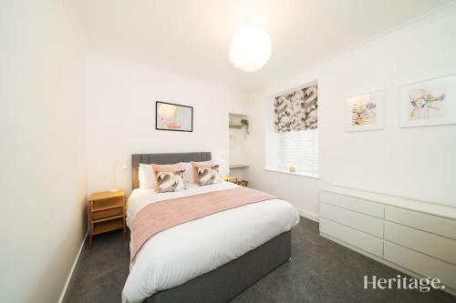 a white bedroom with a bed and a window at Barclay House, Stonehaven Seaside Home in Stonehaven