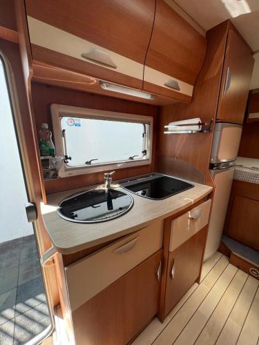 a kitchen with a sink and a counter top at Camper Rent motorhome Albania in Tirana
