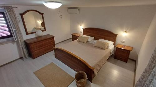 a bedroom with a large bed and a mirror at Casa Šimeti in Poreč