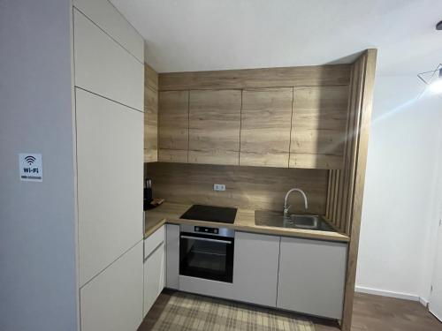 a small kitchen with a sink and a stove at Vuletić in Neum