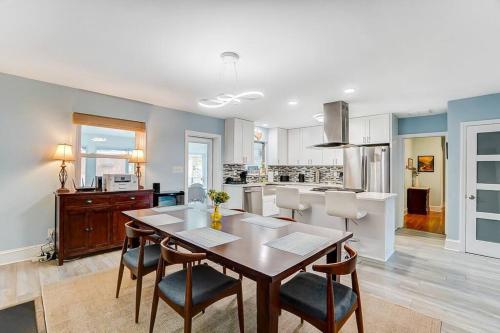 a kitchen and dining room with a table and chairs at Poolside Bungalow with Fire Pit Fun and King Suite in Charlotte
