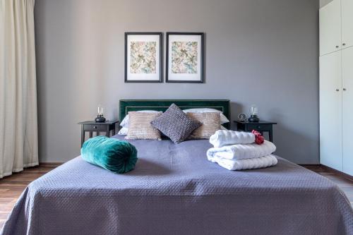 a bedroom with a bed with towels on it at King David Apartment - J&J in Jerusalem