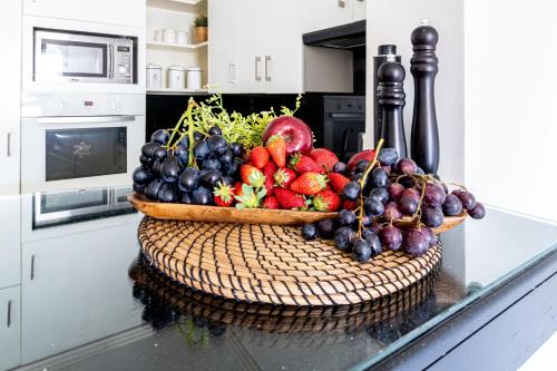 a bowl of fruit on a counter in a kitchen at King David Apartment - J&J in Jerusalem