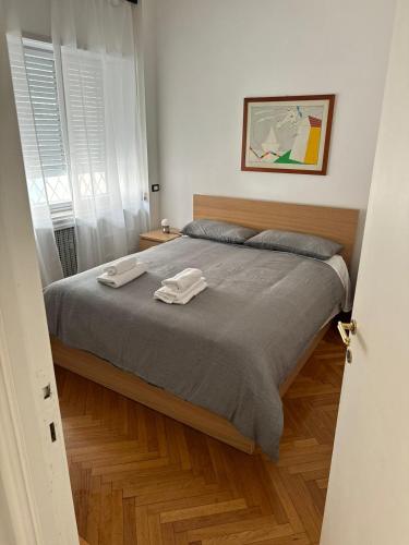 a bedroom with a bed with two towels on it at Micheli Luxury Flat in Rome