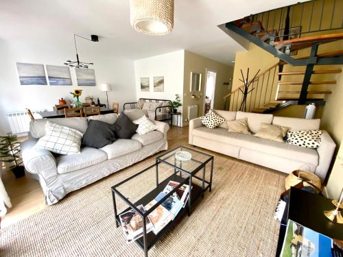 a living room with a couch and a table at Casas La Fuente de Saelices - Alojamiento rural in Saelices el Chico