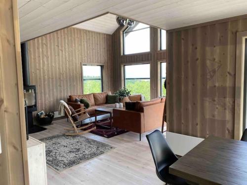 a living room with a couch and a table at Hytte med utsikt over Sunnmørsalpane in Sykkylven