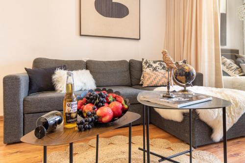 a table with a bowl of fruit and a bottle of champagne at King David Apartment - J&J in Jerusalem