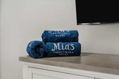 a stack of three blue towels sitting on a counter at Mia's Boutique Hotel in Nags Head