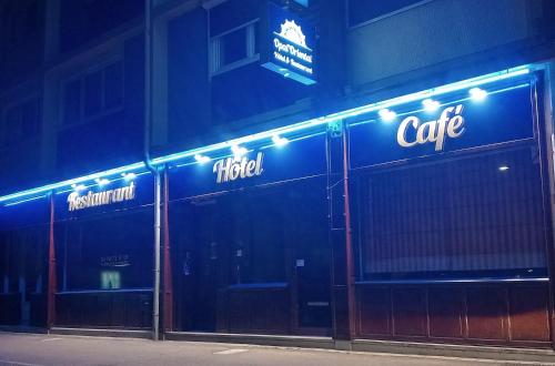 a building with blue lights on the side of it at Hôtel OpalOriental in Boulogne-sur-Mer